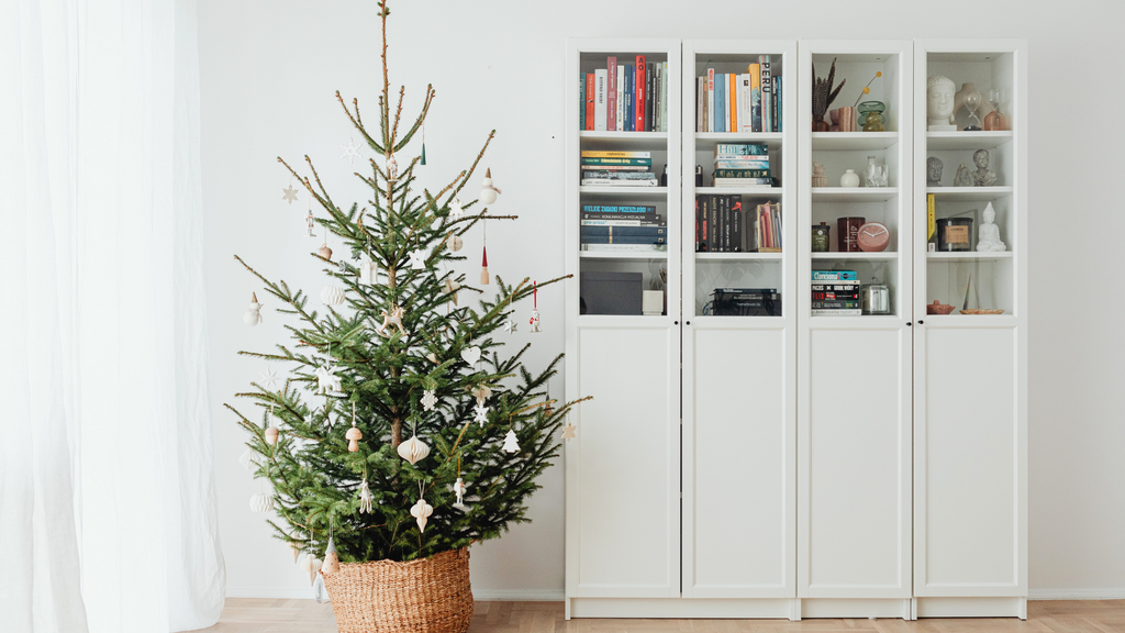 simple christmas tree next to bookcase
