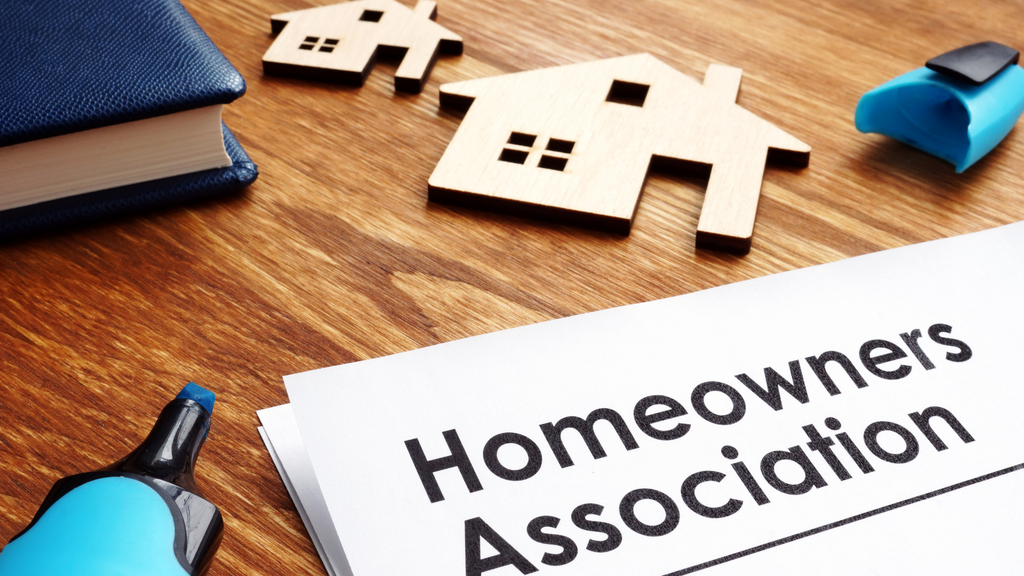 homeowners association paperwork on wooden desk