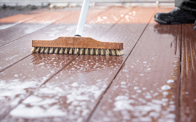 Deck cleaning with brush.
