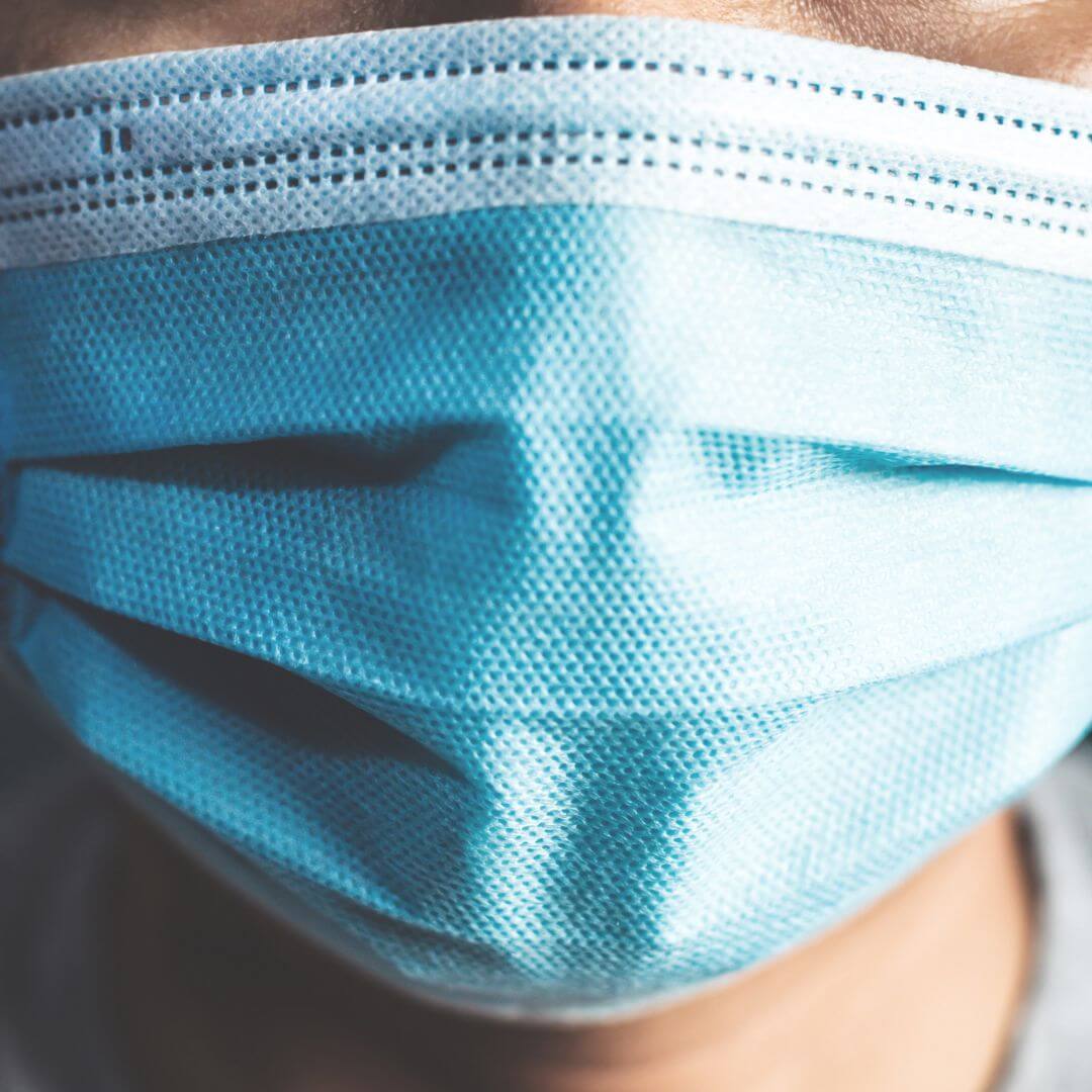 Close-up of a man wearing a face mask, emphasizing the importance of facial protection in preventing the spread of COVID-19.