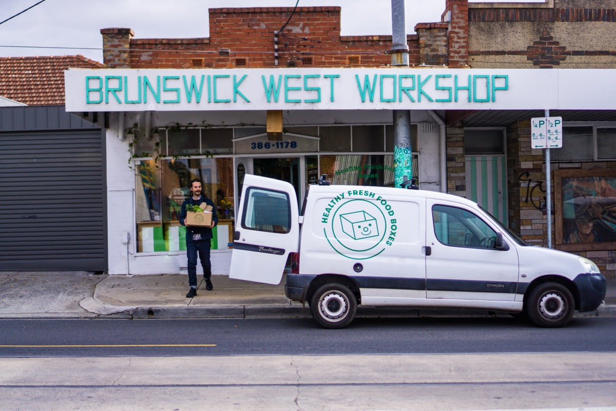 Andrew emerges from the Brunswick West Workshop, on the way to load a Health Fresh Food Boxes into a parked van.