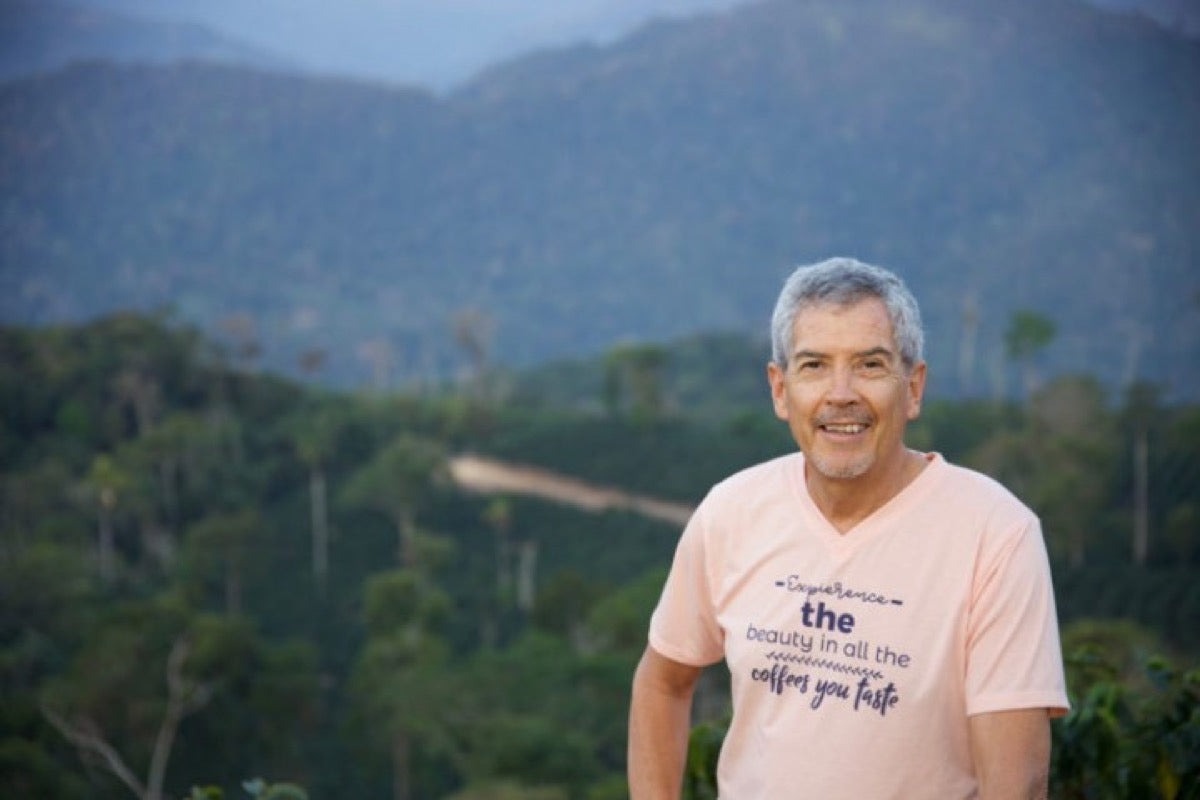 A portrait of Pedro Rodriguez on a forest backdrop.