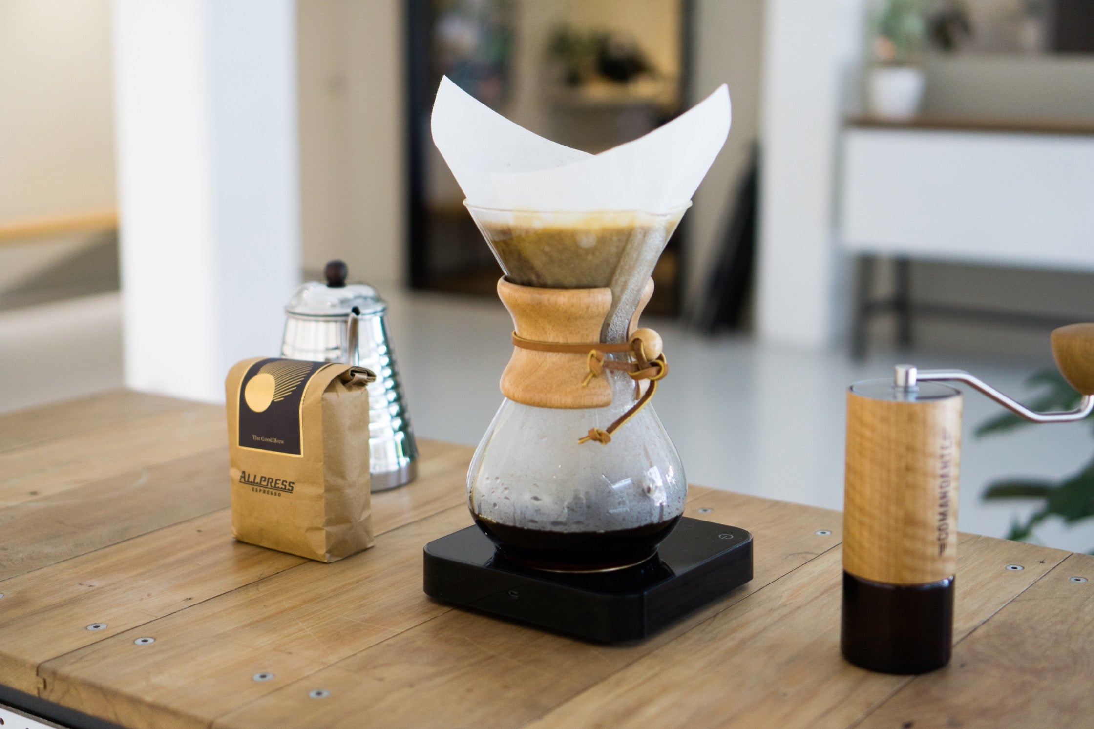 The Chemex setup: a pour-over on a scale, coffee, kettle, and grinder