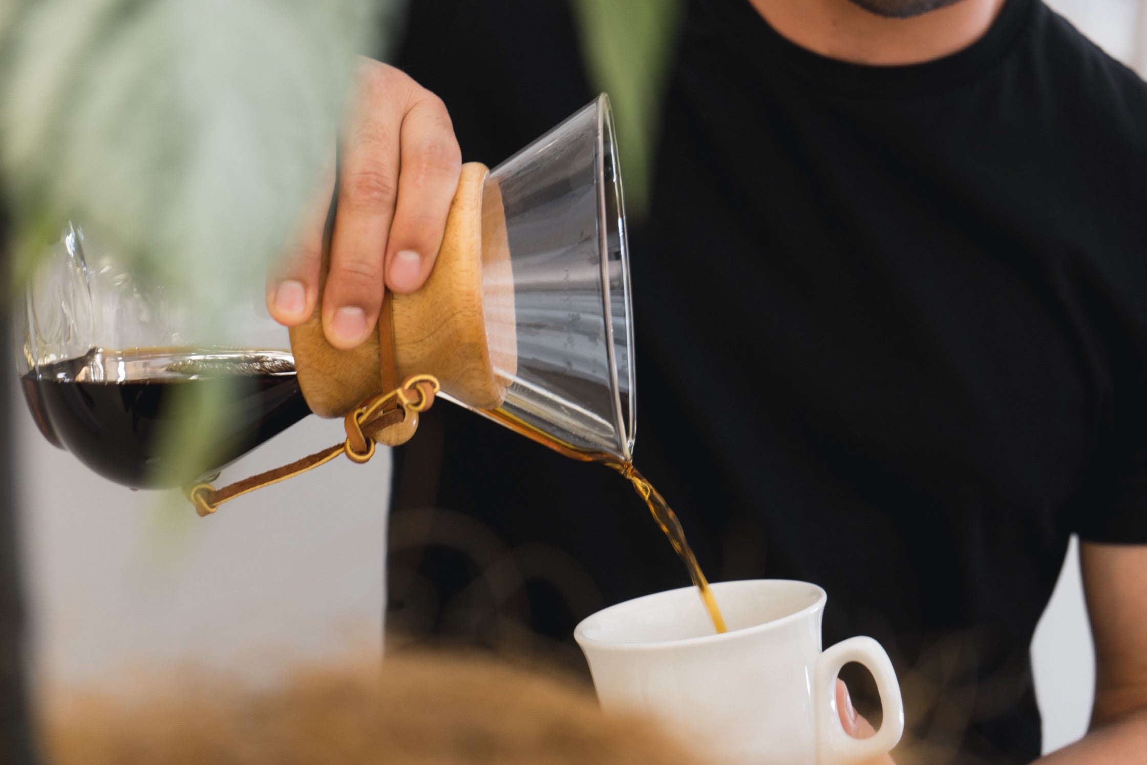 A close-up shot of Charlie pouring coffee into a mug