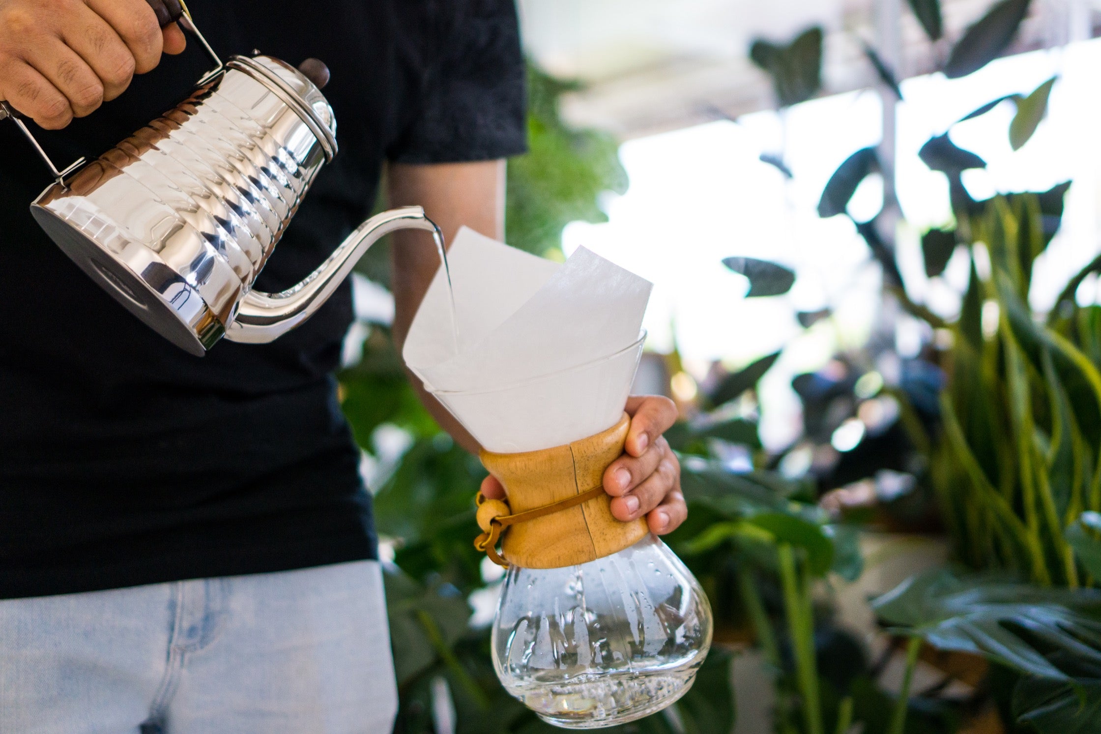 A close-up shot of Charlie adding water to the Chemex