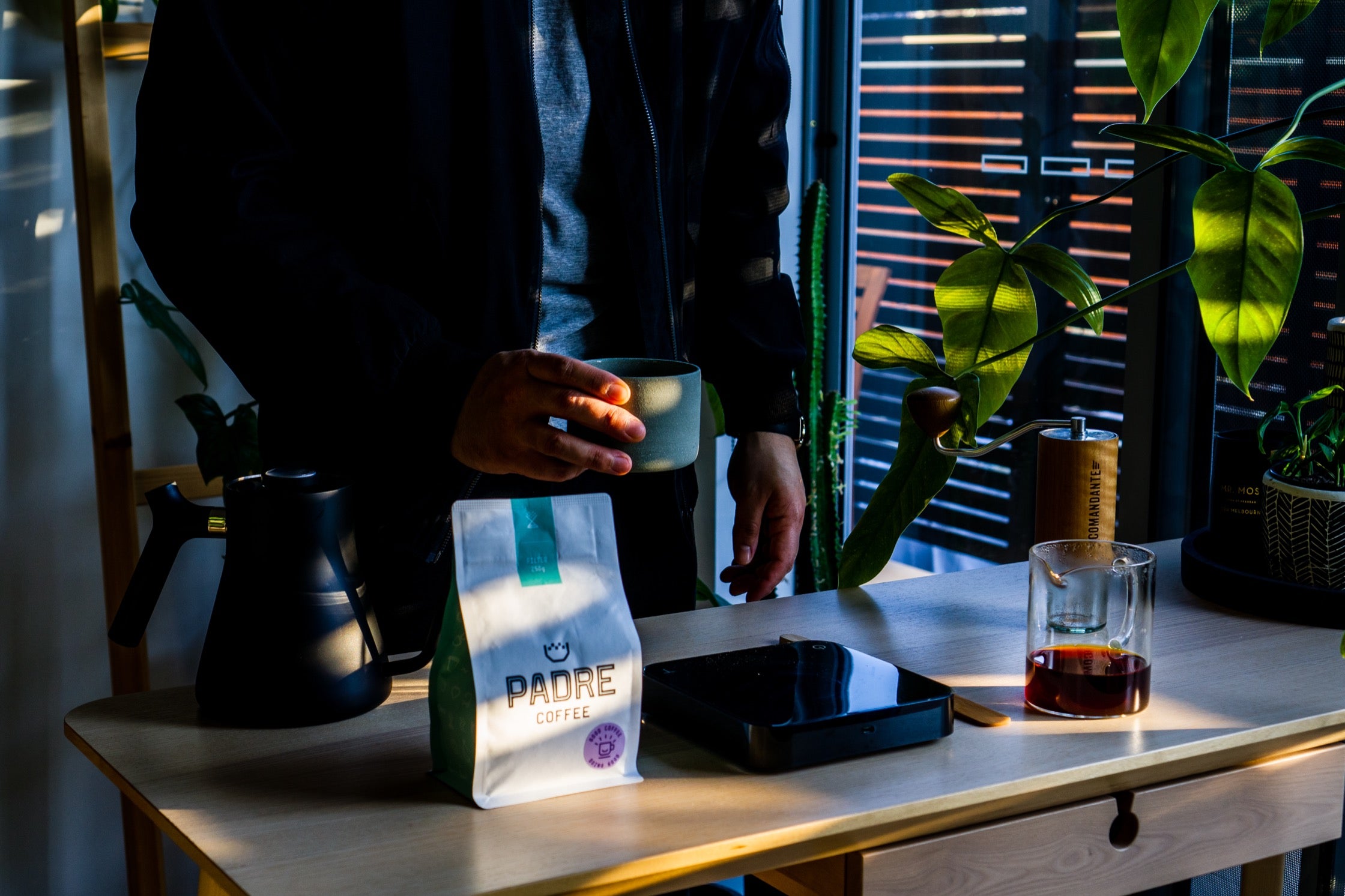 Charlie holds a mug of Padre coffee.