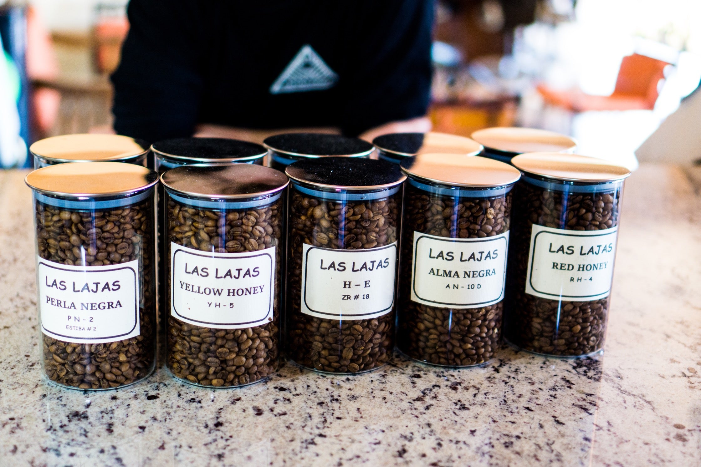 Glass canisters of Las Lajas coffee varieties