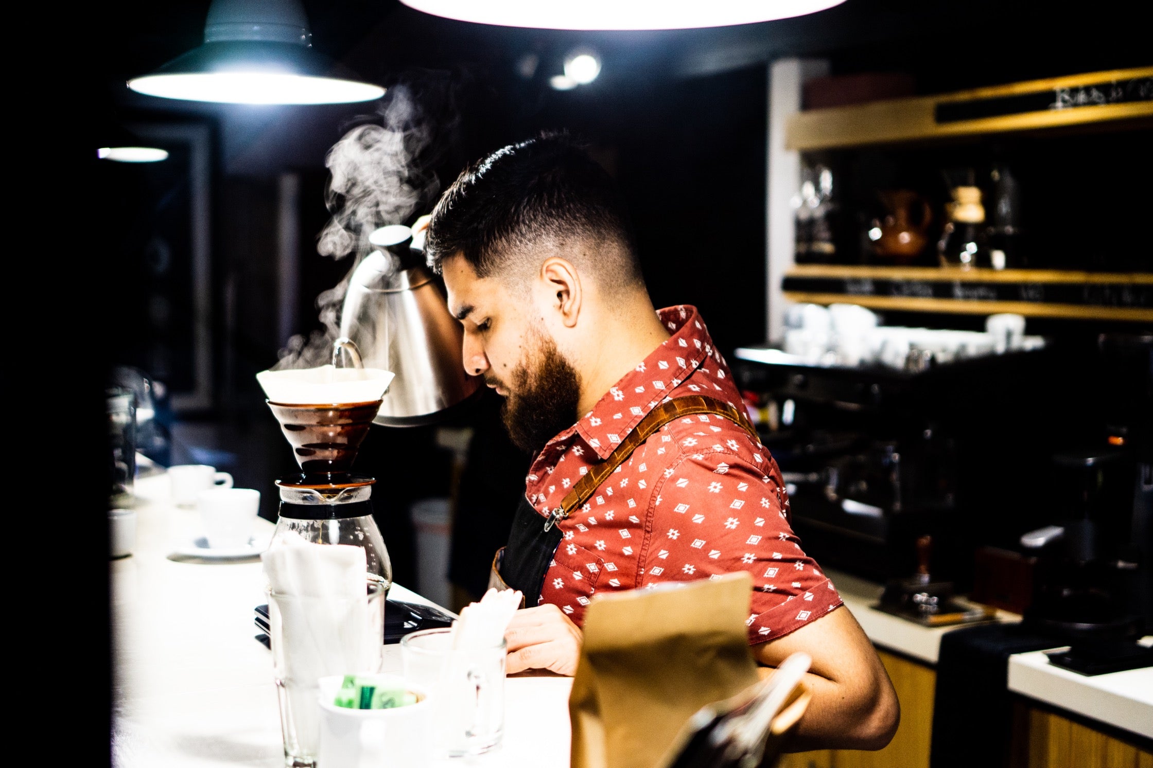 Oscar prepares coffee at La Mancha