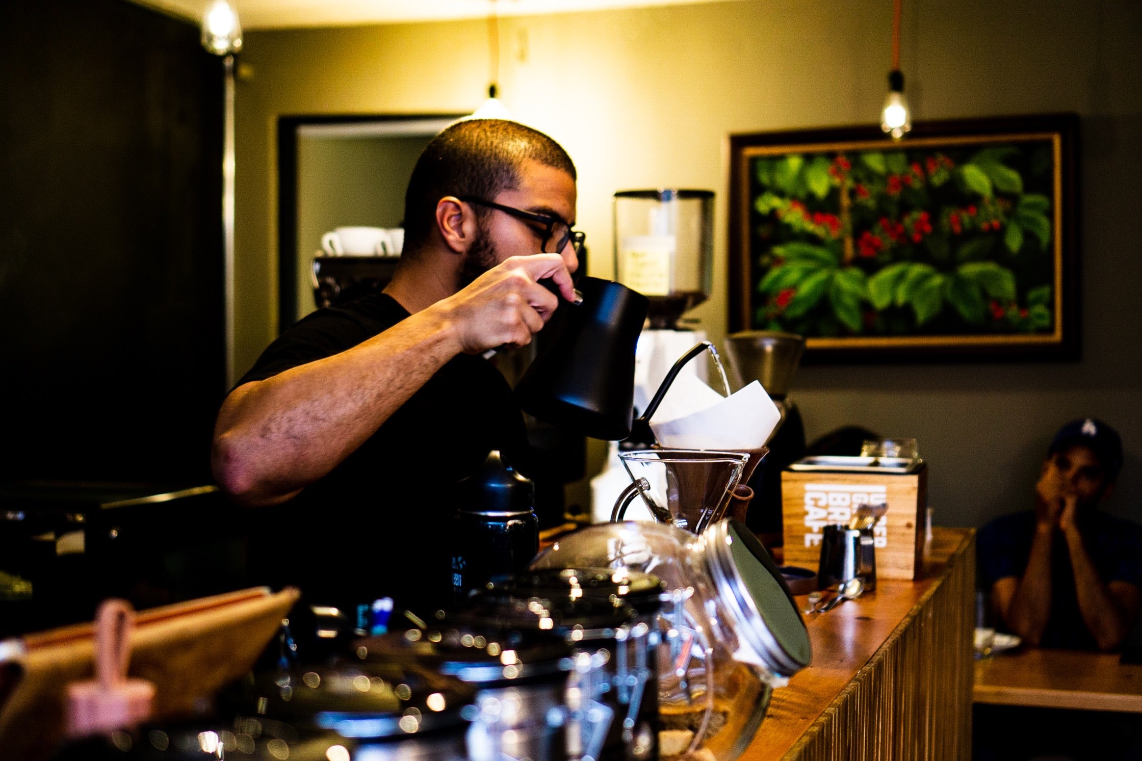 Juan prepares coffee at Underground Brew Cafe