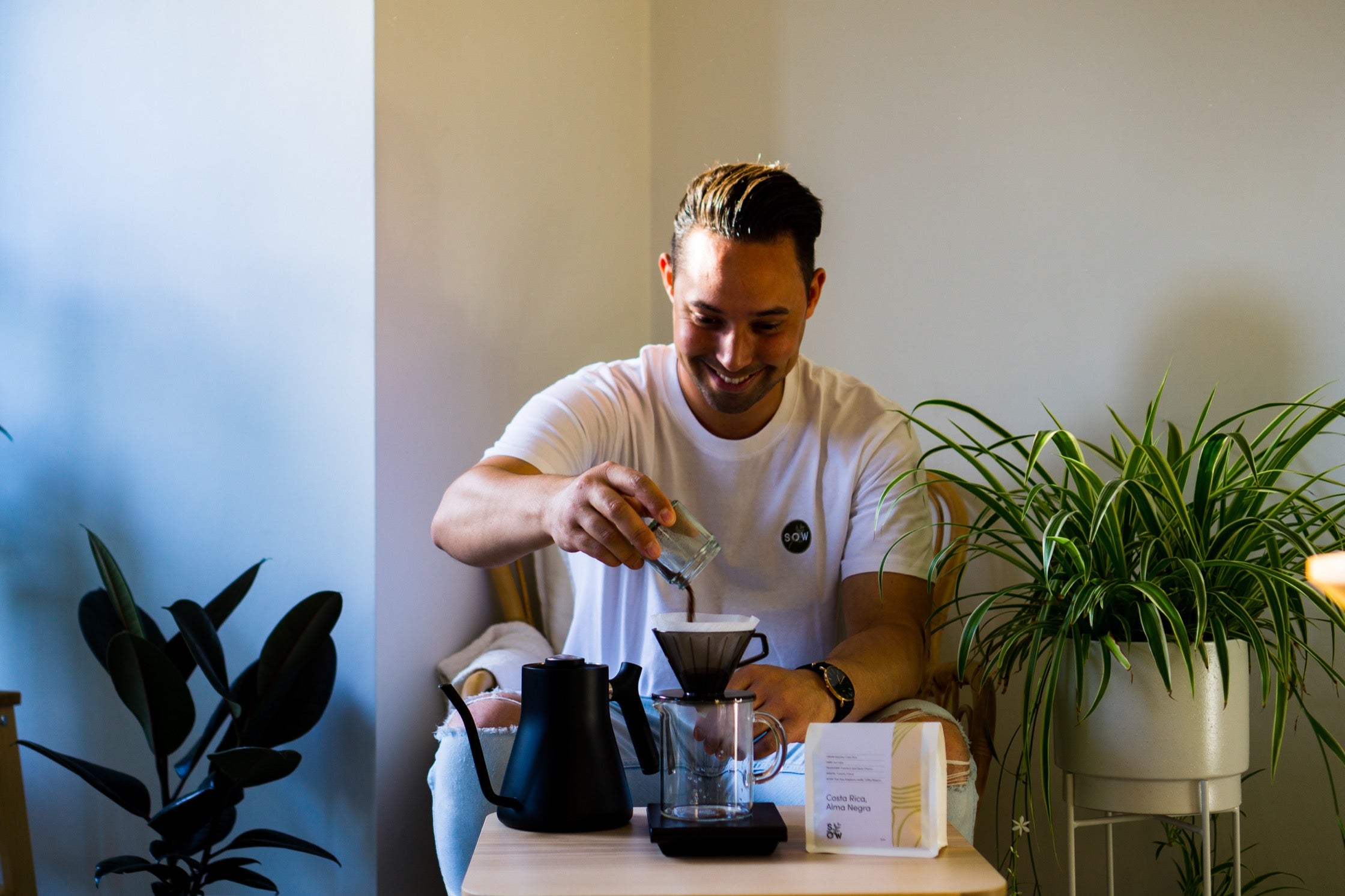 Charlie adds coffee to the pour-over