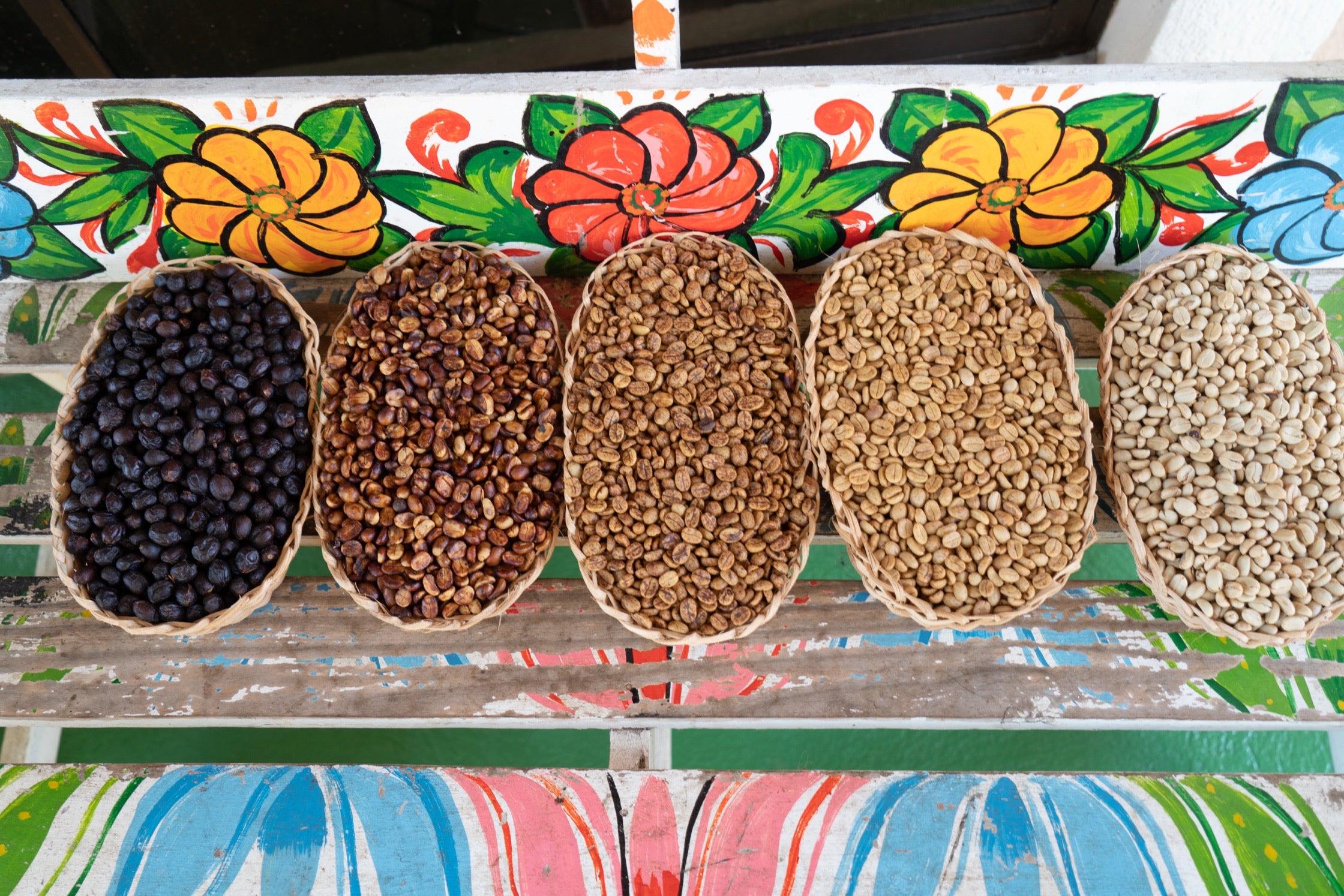 Five baskets of coffee cherries and beans