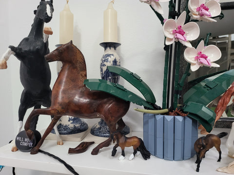 Metal Horse (center) with broken tail.  Stone Rearing Horse on his left and Breyer SM on the right, both with Museum Putty keeping them safe.