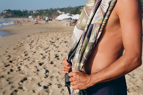 a person holding a towel on a beach
