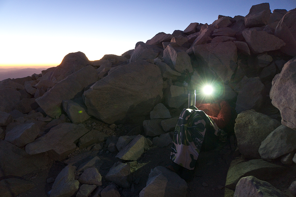 Sean Jansen sitting amongst rocks on a morning hike.