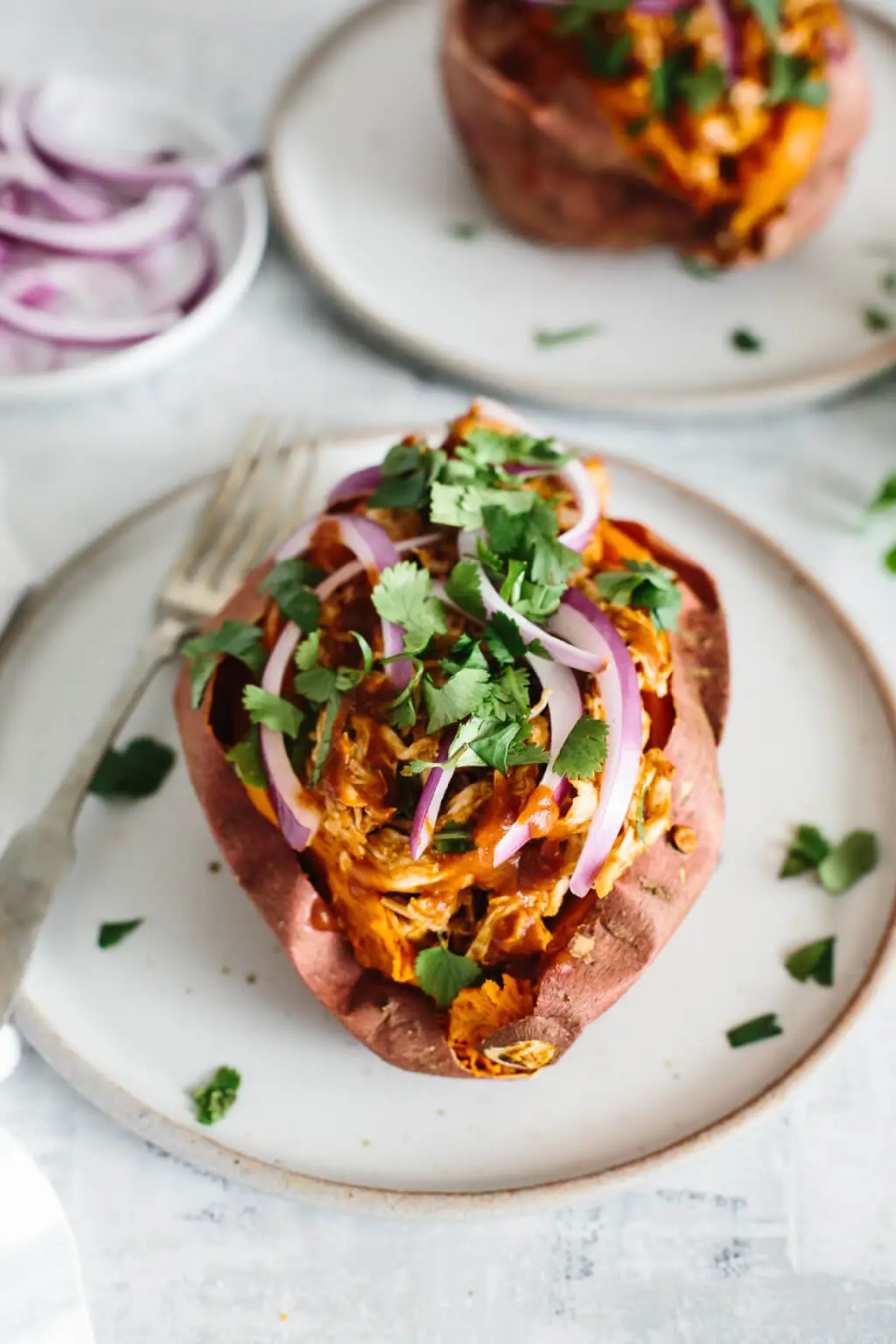 overlay of bbq pulled chicken stuffed sweet potatoes