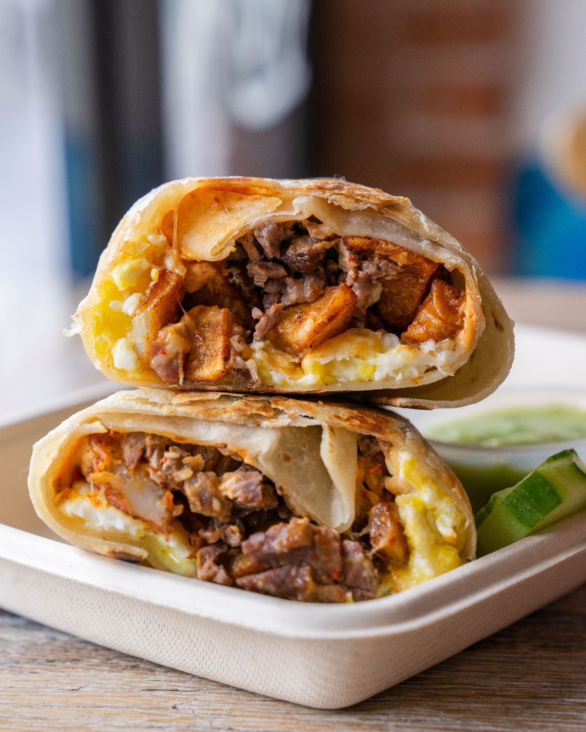 brisket breakfast burrito with lime wedges