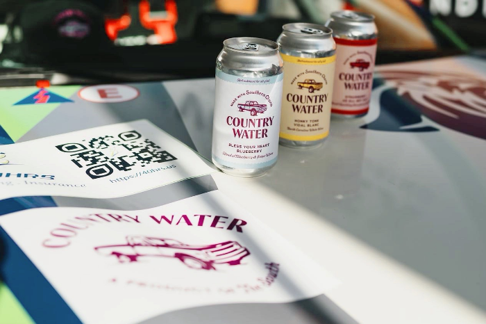 cans of country water on a table