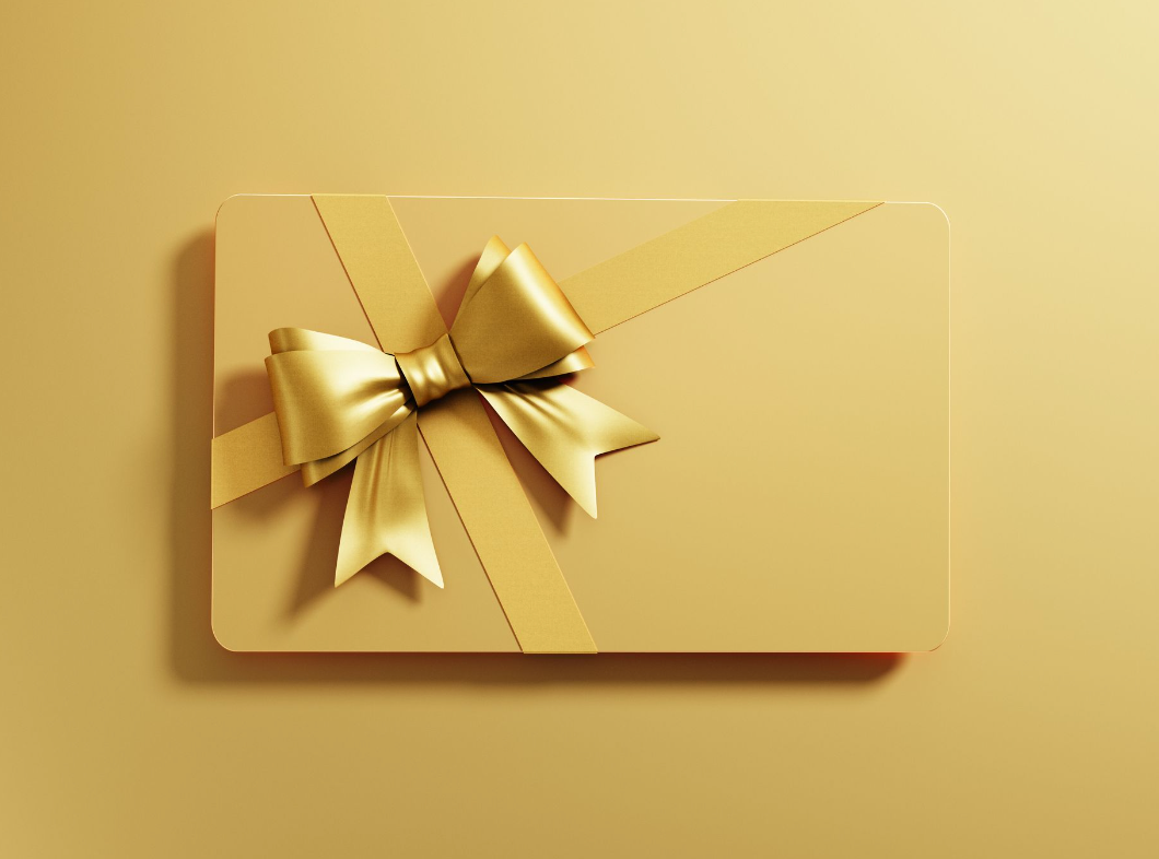 A golden gift card with a bow