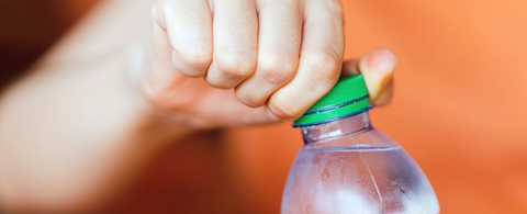 Person opening a plastic bottle