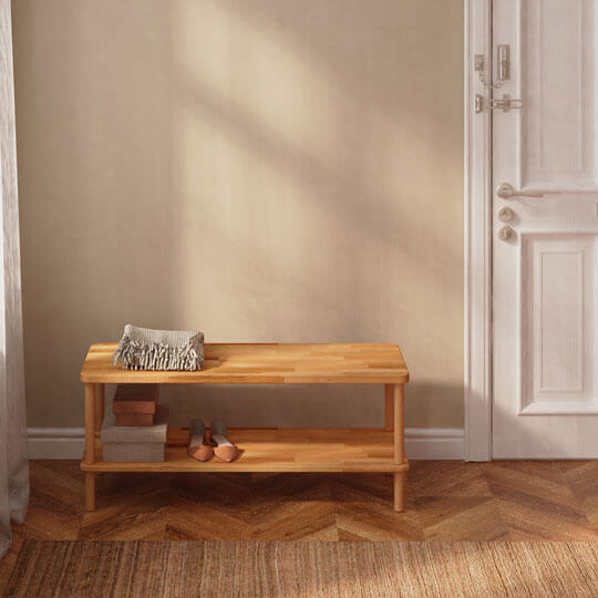 The bench in the entrance hall. There are shoes on the bottom shelf. 