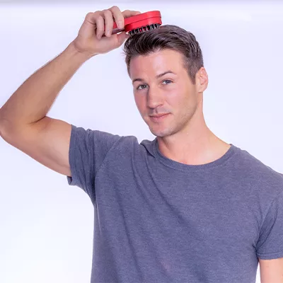 Man promoting hair growth and scalp health with HairPod