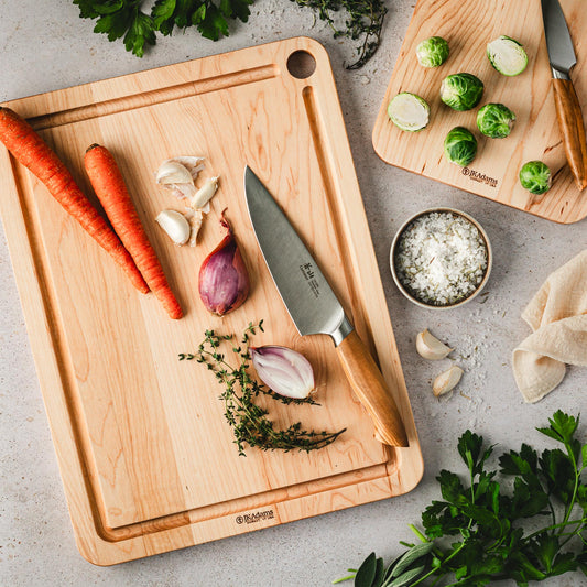 https://cdn.shopify.com/s/files/1/0715/1563/6024/files/JK-ADAMS-CANGSHAN-8-INCH-CHEFS-KNIFE-LIFESTYLE-ON-JK-ADAMS-MAPLE-PREP-BOARD-WITH-SHALLOTS-AND-CARROTS.jpg?v=1699392716&width=533