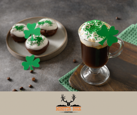 A shamrock latte with green sprinkles on top and st. Patrick’s day cupcakes sitting next to it.