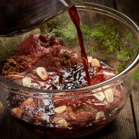 Venison Marinade made with red wine, cloves of garlic and other spices.