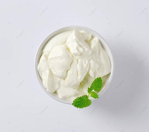 In a pristine bowl, creamy Greek yogurt takes center stage, adorned with vibrant mint leaves, promising a refreshing and indulgent culinary experience.