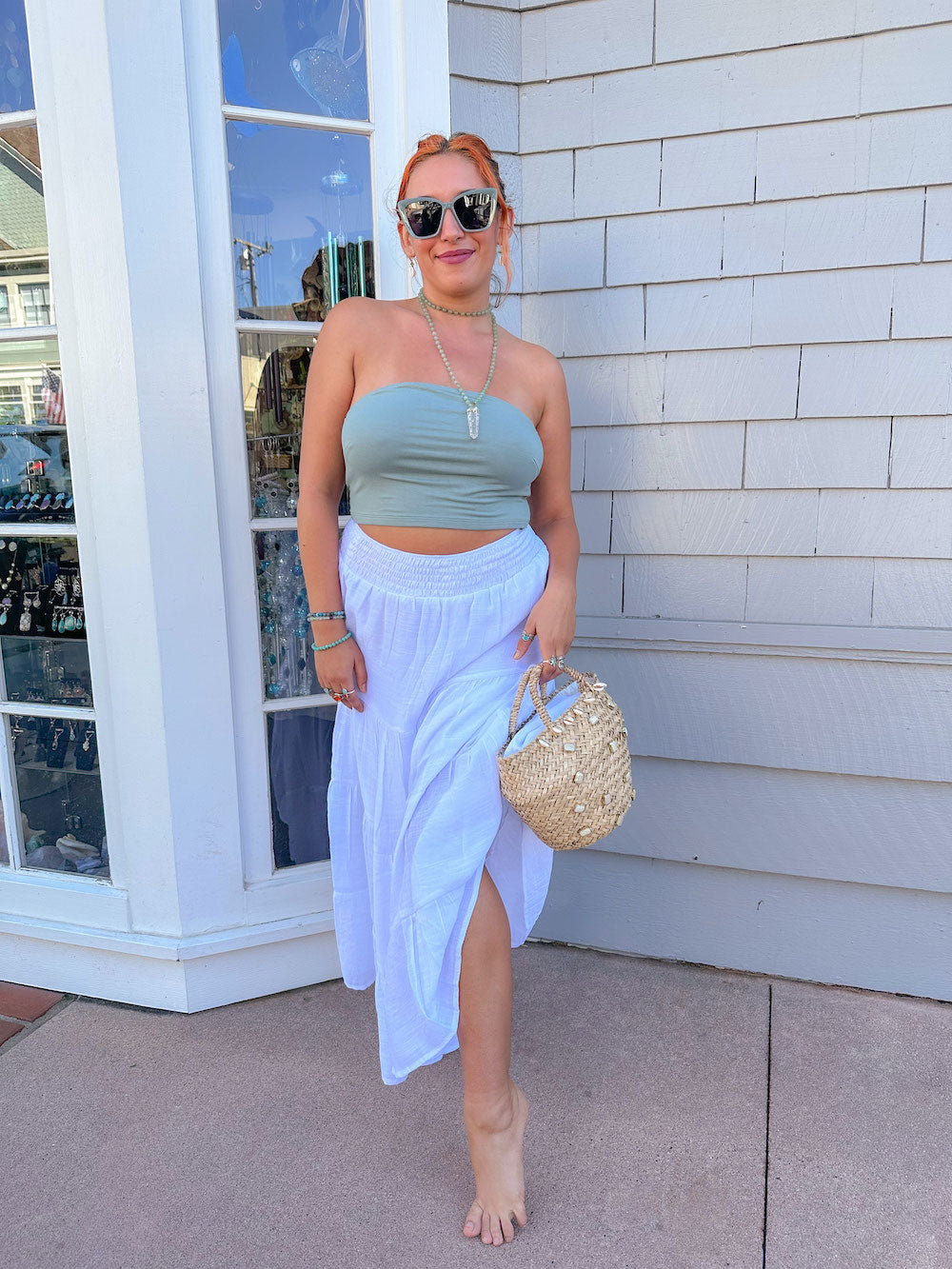 sage green bandeau top paired with white flowy skirt