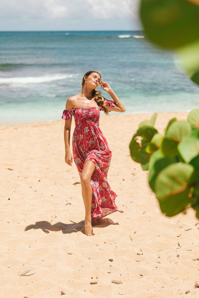 Red maxi dress with colorful floral pattern and slit.