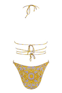 light purple bikini bottoms with gold sun print design and strappy wrap bikini top