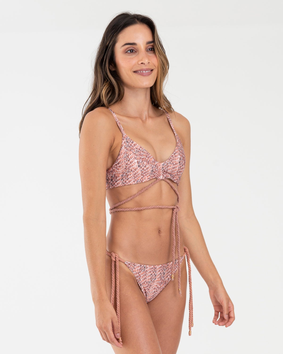 Wrap sporty rose gold colored snake print scoop neck bikini top and matching bikini bottoms with tie side rope details.