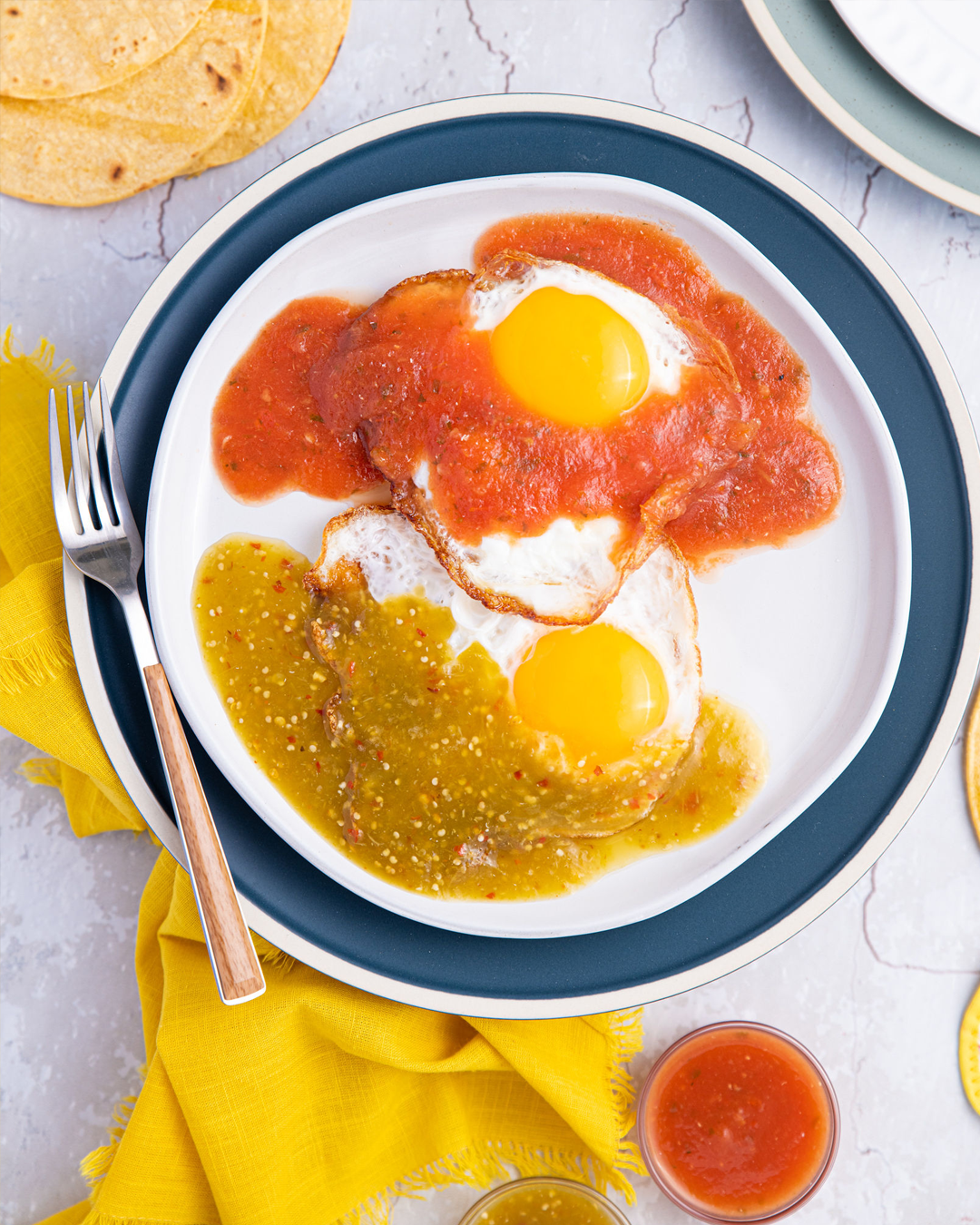 A simple Mexican recipe for fried free-range eggs topped with red and green salsas. | nelliesfreerange.com