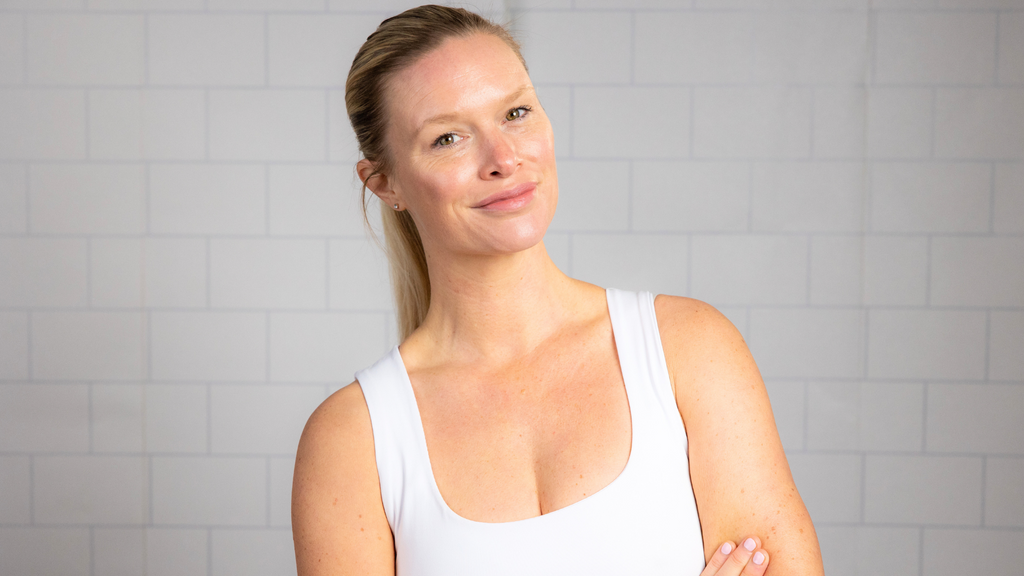 Charlotte Connoley headshot against white tile bathroom wall