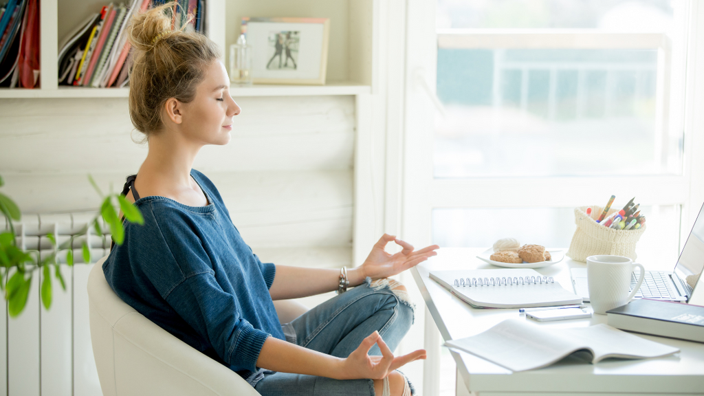 Woman meditating in office chair