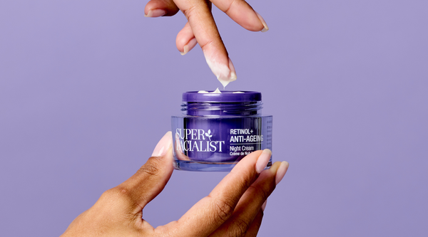 retinol night cream with a finger dipping into the jar