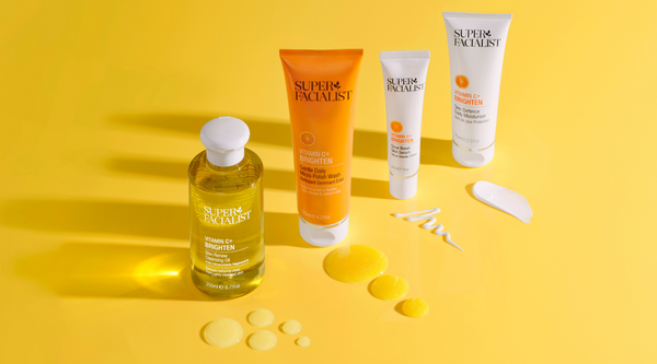 vitamin c glow bundle products on yellow background with cream and oil swatches infront of products