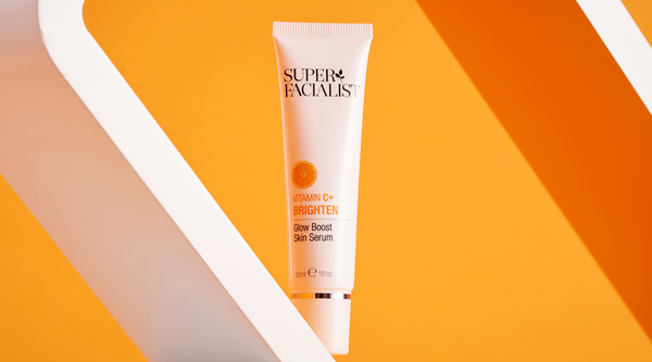 vitamin c glow boost serum against yellow background