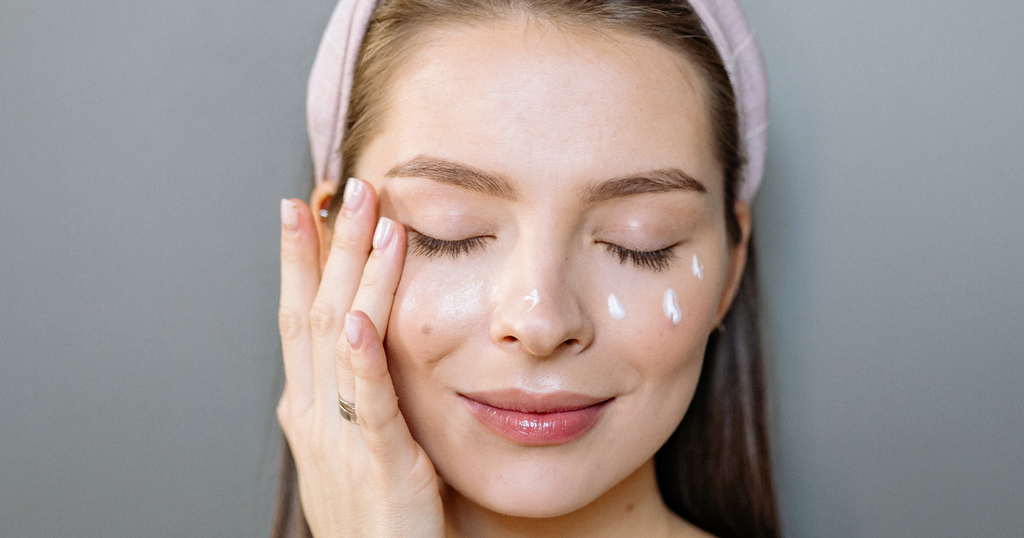 woman applying eye cream to the eye area
