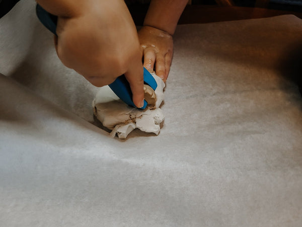 Toddler playing with non-toxic Paperclay