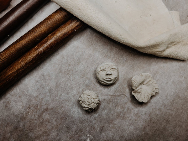 Paperclay studs being carved
