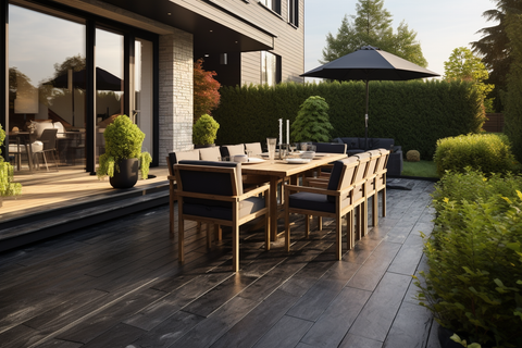 beautiful outdoor patio with tables on wood-look flooring and natural stone walls