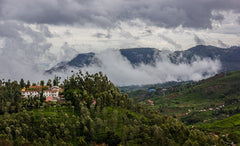 Image of the countryside in Nilgiri, India with clouds settling over the hills.