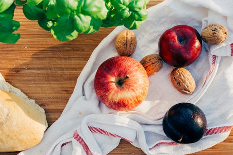 fruit and walnuts on white tablecloth