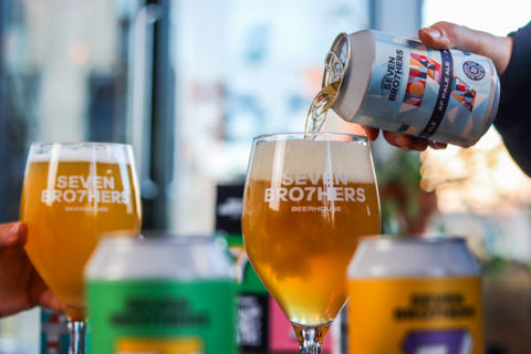 A can of AF beer being poured into a glass.