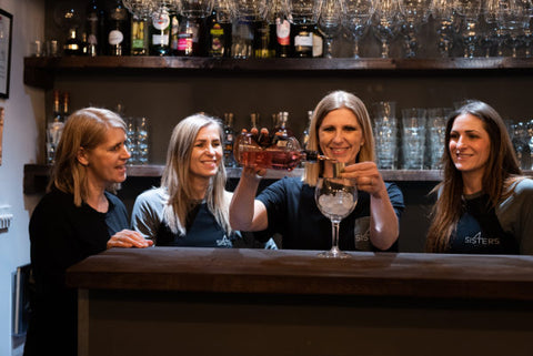 A photo of our four sisters pouring a gin.