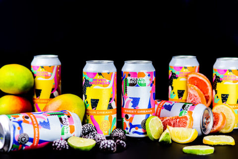 Cans of Sweet and Sour Dreams with fruit surrounding.