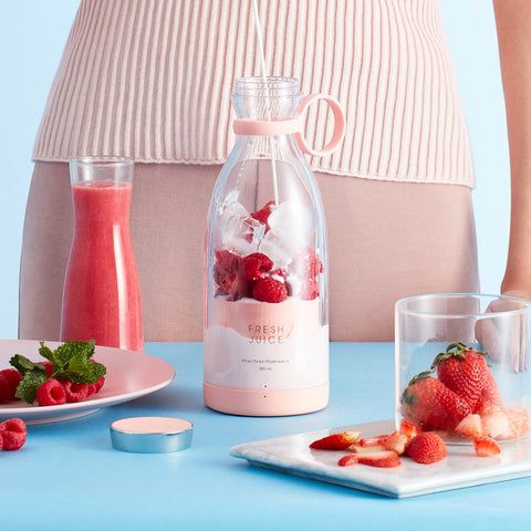 Serving suggestion: A woman making a smoothie with strawberries and raspberries to demonstrate the ample size.