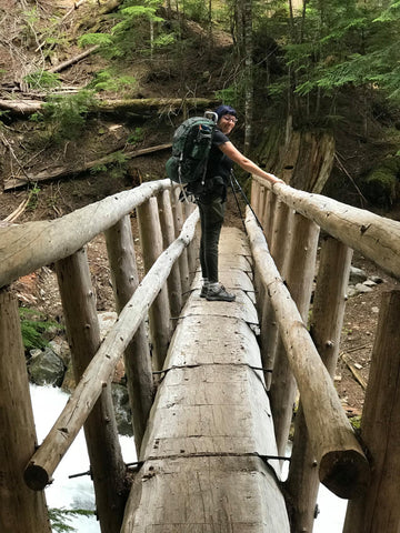 backpacking and hiking across a bridge